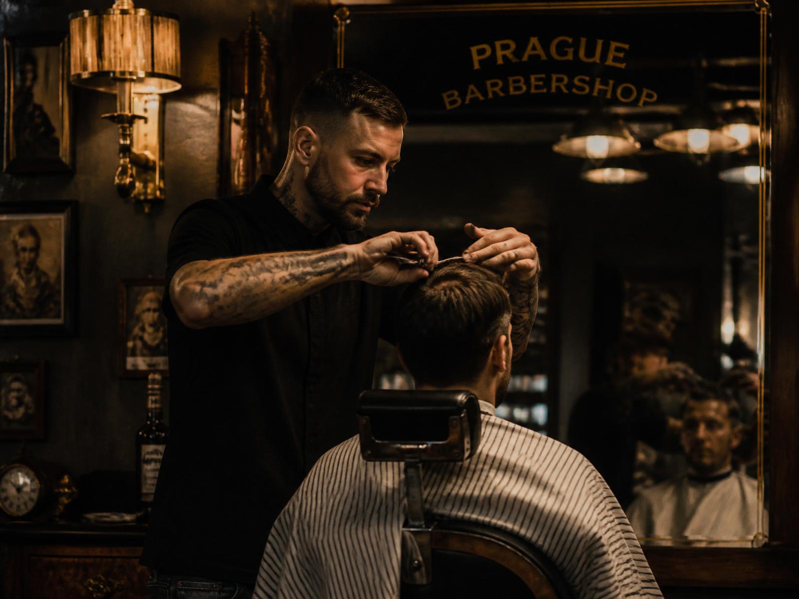 Barber cutting a client's hair at Prague Barber Shop